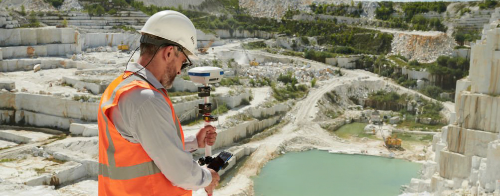 Topógrafo trabajando con equipo GNSS en predio rústico en Ñuble